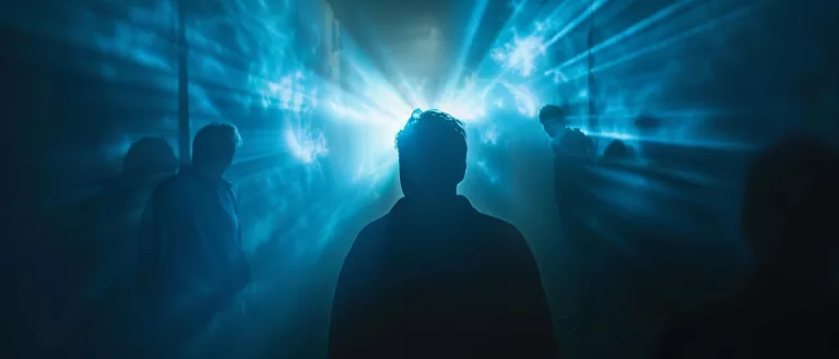 Silhouette de dos face à une lumière bleue intense et brumeuse, illustrant les vœux 2026 de l'agence gcom et la volonté d'avancer vers l'avenir malgré l'incertitude.